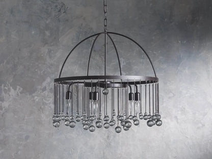 A round chandelier made of solid iron with five exposed bulbs and hanging glass accents, suspended by an iron chain.