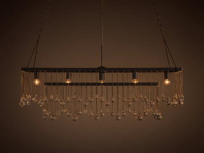Aubrey Rectangular Chandelier with solid iron frame, hanging glass spheres, and five exposed bulbs, suspended by black iron chains.