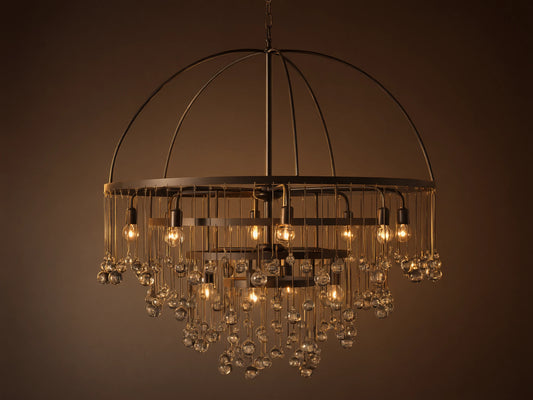 A round chandelier with a dark iron frame, featuring cascading glass orbs and five visible lit bulbs, hanging from a chain.