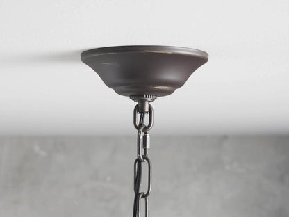 Aubrey Round Chandelier with dark iron rings, featuring hanging glass balls and lit bulbs creating an elegant ambiance.