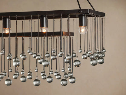 Aubrey Rectangular Chandelier: dark iron frame, 5 exposed bulbs, and many clear glass beads hanging at varying lengths.