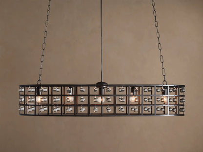 La Cage Oval Chandelier: Dark metal cage frame, oval-shaped, adorned with clear crystal spheres and glowing bulbs, suspended by chains.