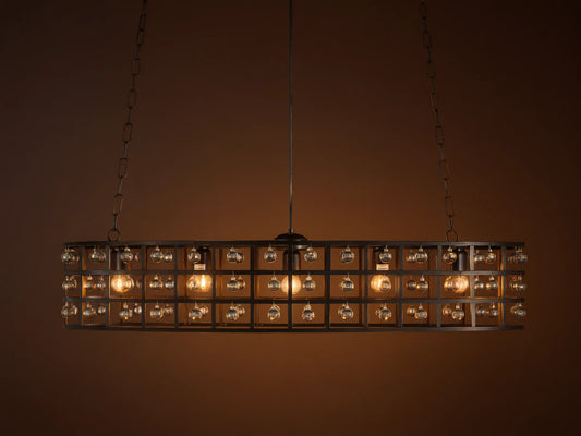 La Cage Oval Chandelier: Dark metal cage frame, oval-shaped, adorned with clear crystal spheres and glowing bulbs, suspended by chains.