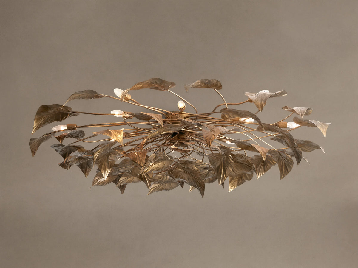 Ornate Ninfea Flush Mount with antiqued gold iron leaves and multiple illuminated candelabra bulbs on a neutral ceiling.
