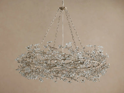 Fiore Crown Chandelier: Ornate silver-finished metal frame, adorned with numerous small, clear crystal flowers, hanging from chains.