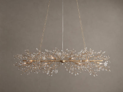 Fiore Linear Chandelier, golden finish, adorned with delicate branching crystal leaves, exposed candelabra bulbs, suspended by chains.