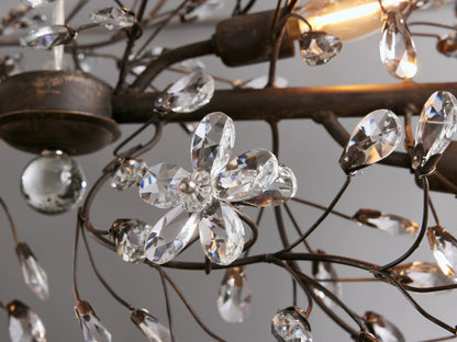 Fiore Linear Chandelier: horizontal, dark iron frame with delicate branches adorned with clear crystal flower accents, suspended by chains.