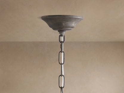Fiore Crown Chandelier: Close-up of rustic dark bronze canopy and chain hanging from a light beige ceiling.