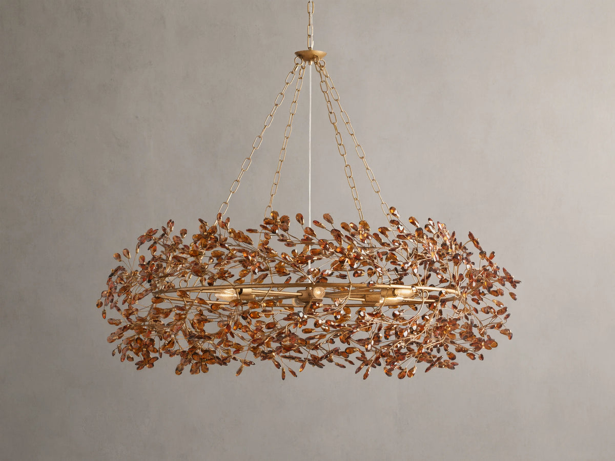 Fiore Crown Chandelier with golden antiqued leaf design, hanging by iron chains, features intricate floral patterns and multiple bulb sockets.