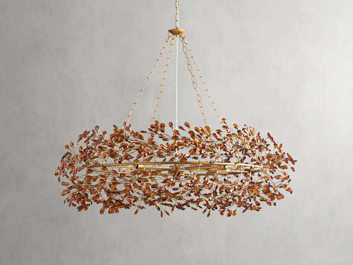 Fiore Crown Chandelier with golden antiqued leaf design, hanging by iron chains, features intricate floral patterns and multiple bulb sockets.