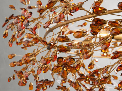Fiore Crown Chandelier with gold antiqued leaf design, suspended by chains, showcasing ornate leaf details on iron frame against gray background.