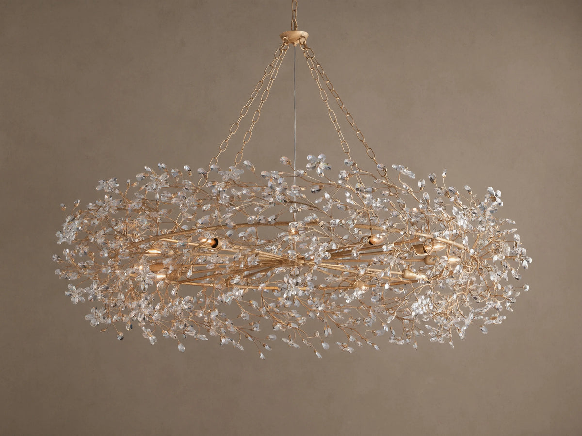 Gold Fiore Crown Chandelier, an oval-shaped light fixture adorned with countless clear crystal flowers, hanging from chains.