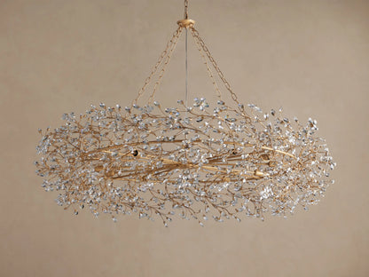 Fiore Crown Chandelier: Oval-shaped golden chandelier with chains, densely covered in sparkling clear crystal leaves.
