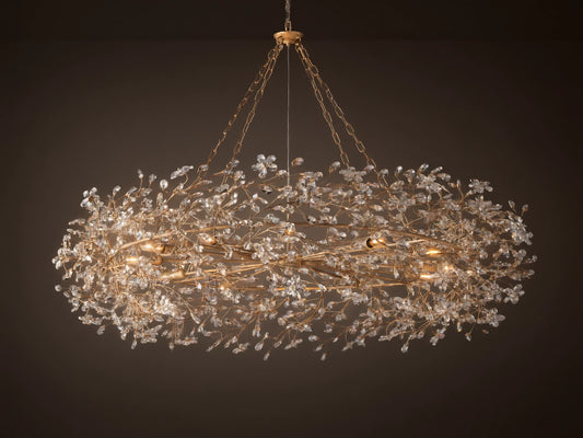 Gold Fiore Crown Chandelier, an oval-shaped light fixture adorned with countless clear crystal flowers, hanging from chains.
