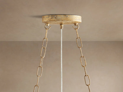Close-up of Fiore Oval Chandelier: gold branches adorned with clear, sparkling crystal flowers and teardrop-shaped gems.