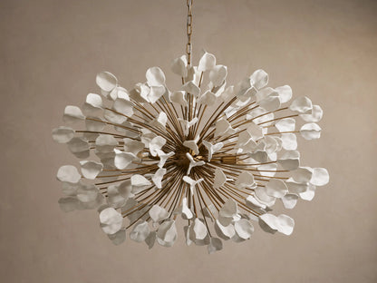 Lunaria Chandelier featuring a burst of 160 ceramic leaves in white and gold tones; warm light emitted from center bulbs.