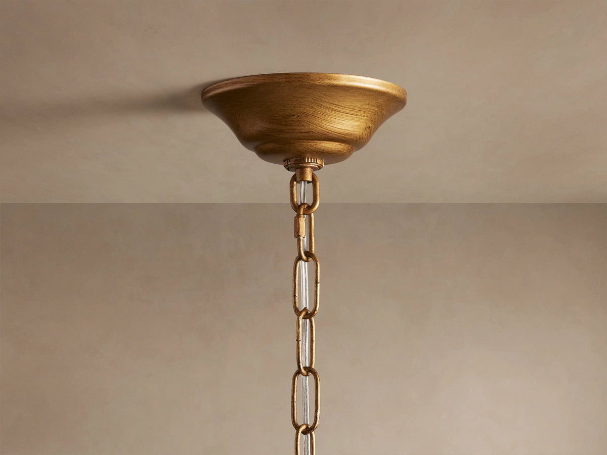 Ceramic leaves of the Lunaria Chandelier in soft white, attached to golden iron stems, creating an elegant, illuminated look.