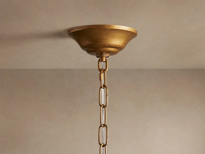 Ceramic leaves of the Lunaria Chandelier in soft white, attached to golden iron stems, creating an elegant, illuminated look.