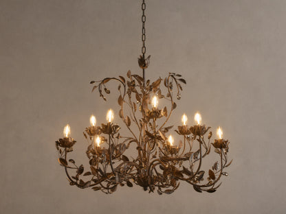 Nicoletta Round Chandelier, bronze metal with intricate leafy vines, 8 glowing candelabra bulbs, and dark crystal accents.