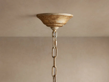 Close-up of Nicoletta Round Chandelier featuring gold metallic leaves, clear crystal accents, and warm glowing bulbs.