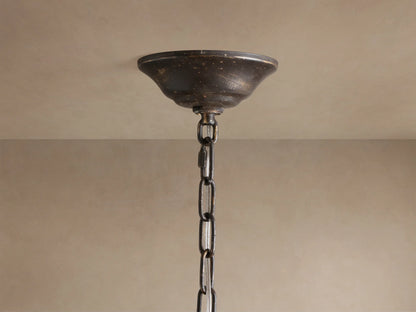 Nicoletta Round Chandelier close-up, showing bronze branches, leaves, smoke-colored crystals, and lit bulbs.