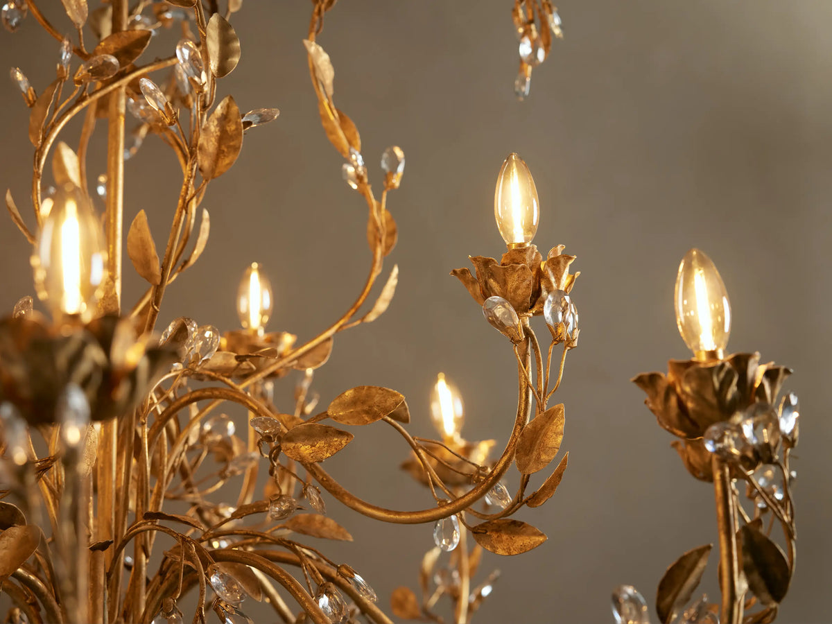 Gold Nicoletta Round Chandelier with intricate vine and leaf metalwork, multiple clear crystal accents, and candle-style bulbs.