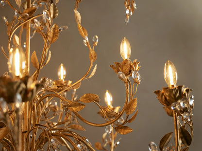 Gold Nicoletta Round Chandelier with intricate vine and leaf metalwork, multiple clear crystal accents, and candle-style bulbs.