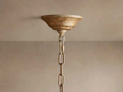 Close-up of Nicoletta Round Chandelier, golden leaf-like metalwork with clear crystal accents, and warm glowing light bulbs.