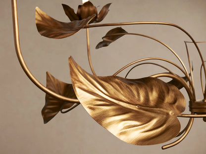 Ninfea Chandelier, an ornate antiqued gold fixture with five detailed lily-like flower bulb holders and numerous delicate leaves.
