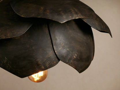 Lorca Pendant, a dark, layered flower-shaped fixture with antique brass/bronze tones, hanging from a cord.