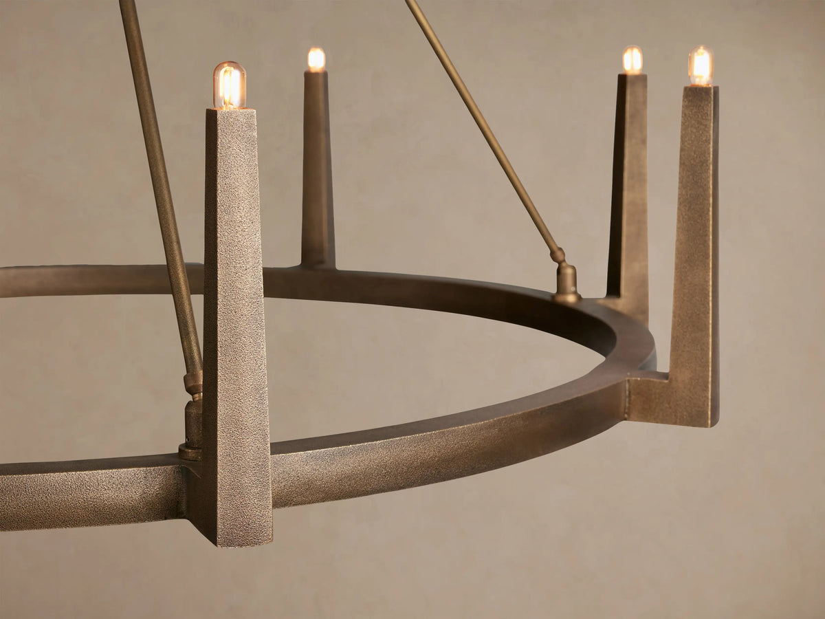 Emmet Round Chandelier with antiqued brass finish, round, featuring ten upward-pointing lights, suspended from ceiling.