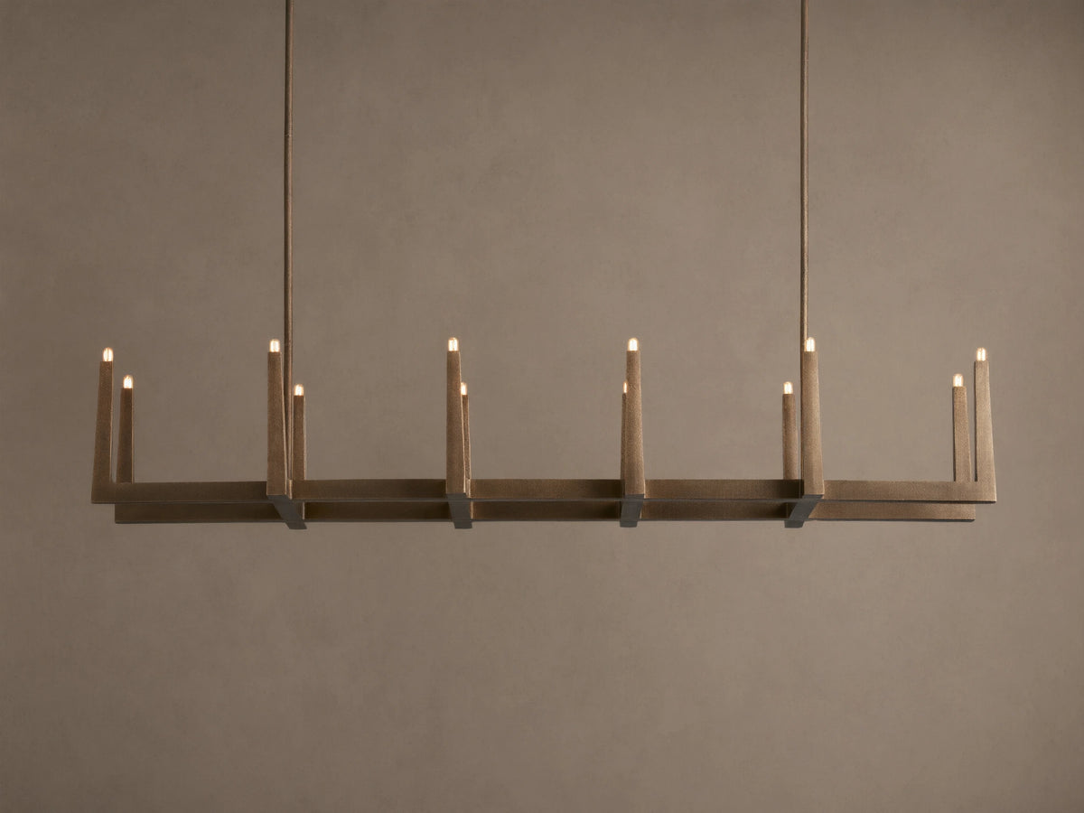 Emmet Linear Chandelier in antiqued brass, hanging horizontally. Rectangular frame features 10 lit, candelabra-style bulbs.