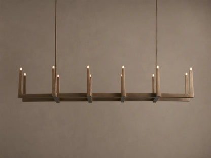 Emmet Linear Chandelier in antiqued brass, hanging horizontally. Rectangular frame features 10 lit, candelabra-style bulbs.