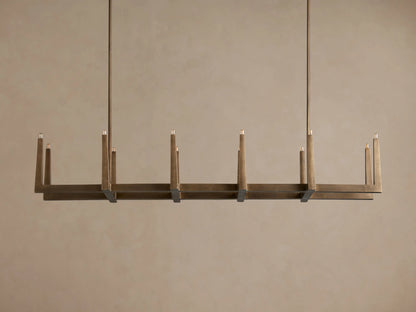Emmet Linear Chandelier in antiqued brass, hanging horizontally. Rectangular frame features 10 lit, candelabra-style bulbs.