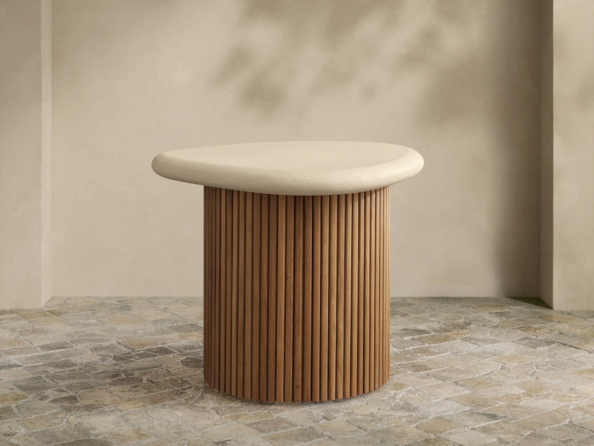 Alesso Outdoor End Table: beige, rounded top on a cylindrical base of natural wood slats, on a light stone floor.