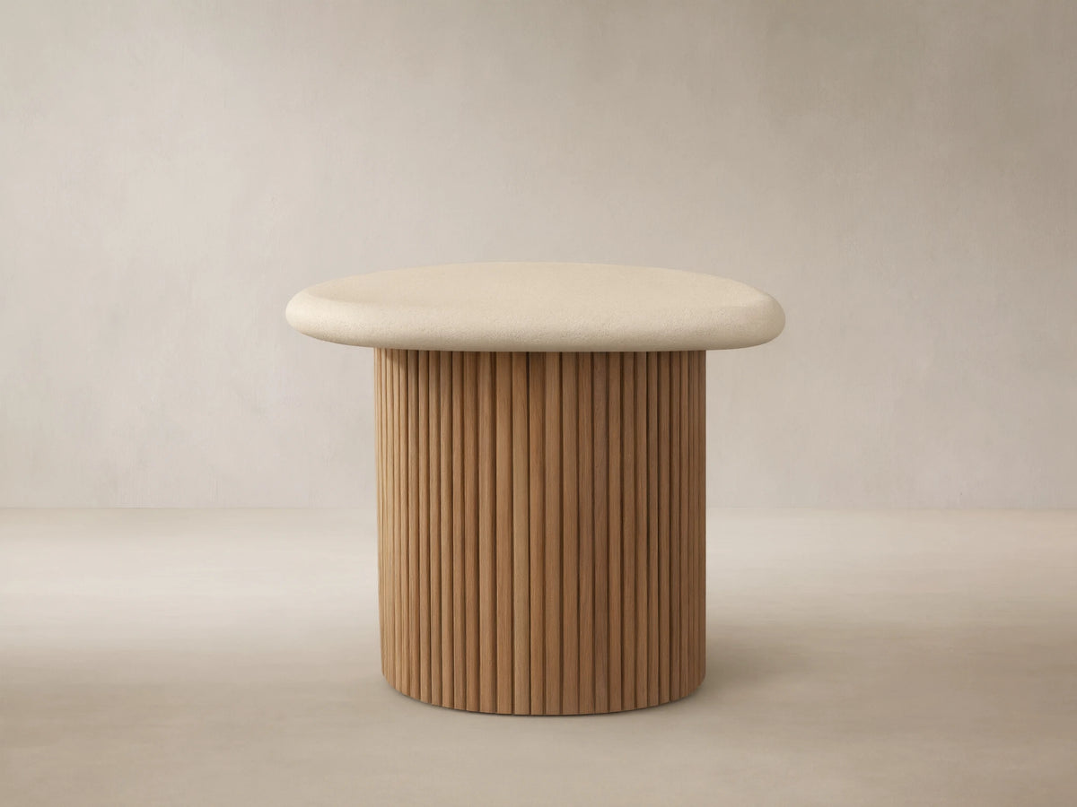 Alesso Outdoor End Table: beige, rounded top on a cylindrical base of natural wood slats, on a light stone floor.