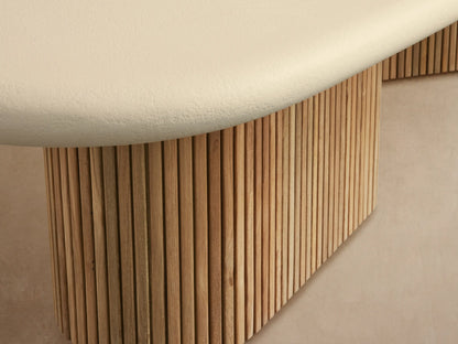 Alesso Outdoor Coffee Table: Light cream oval top, two bases of vertical light brown wood slats on stone patio.