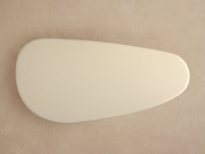 Close-up of Alesso Outdoor Coffee Table showing textured cream top and curved base of vertical natural wood slats.