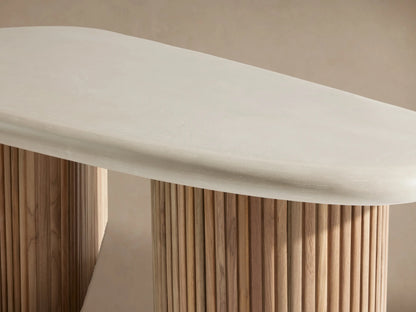 Alesso Outdoor Coffee Table: Light oval tabletop on two curved natural wood slat bases. Outdoor setting with stone patio.
