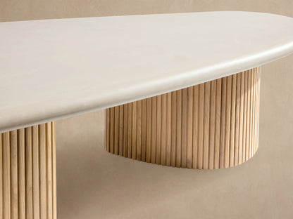 Alesso Outdoor Coffee Table: oval white top on two natural wood slatted cylindrical bases, on a light stone patio.