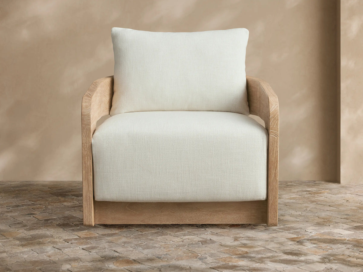 Light grey Anami outdoor collection cover draped over a chair, front view. It has a central seam and a split bottom opening.