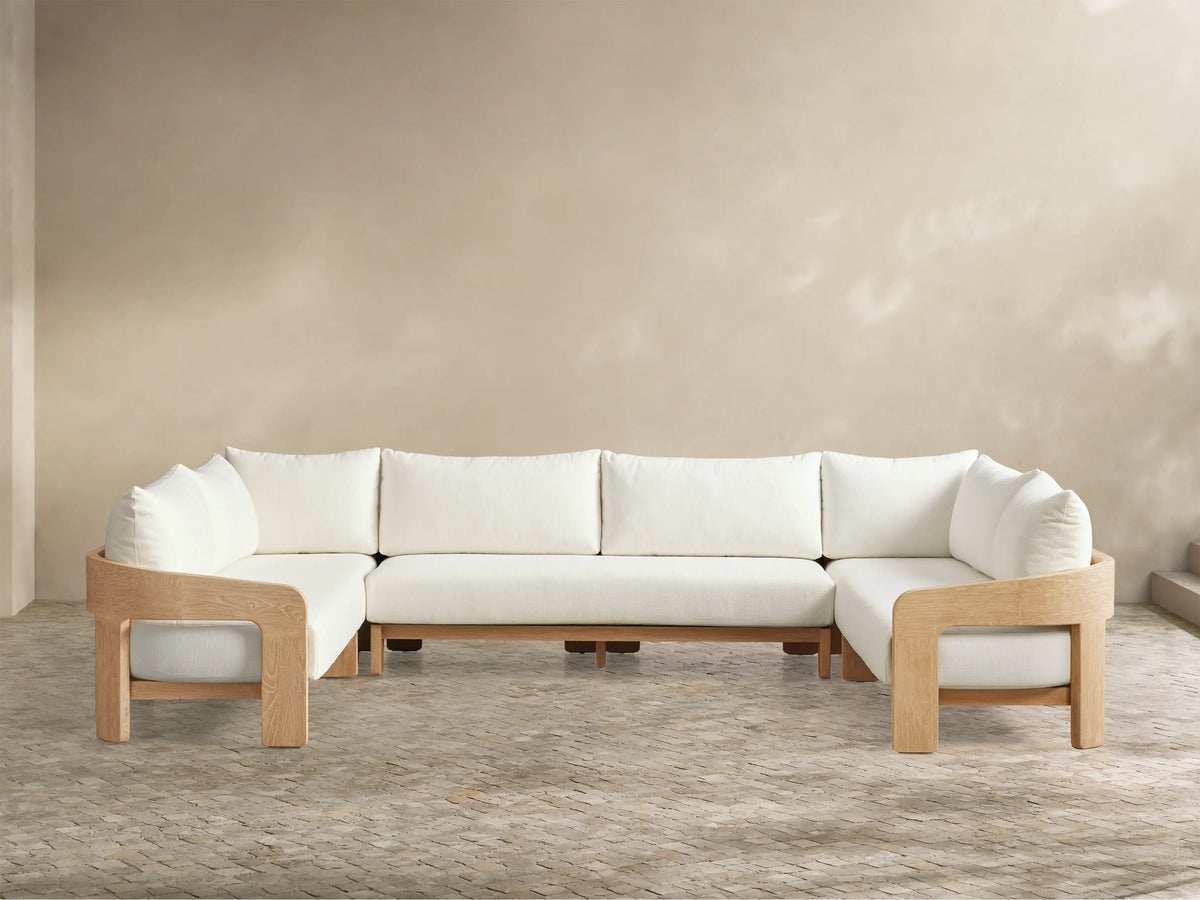 Front view of the U-shaped Anami Outdoor Three-Piece Sectional with light teak frame and white cushions.