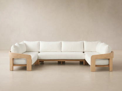 Front view of the U-shaped Anami Outdoor Three-Piece Sectional with light teak frame and white cushions.