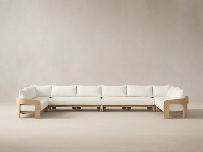 Front view of the Anami Outdoor Four-Piece Sectional with natural teak wood frame and white cushions.