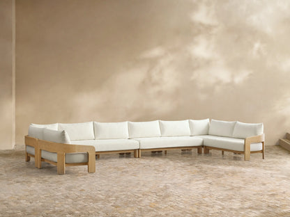 Front view of the Anami Outdoor Four-Piece Sectional with natural teak wood frame and white cushions.