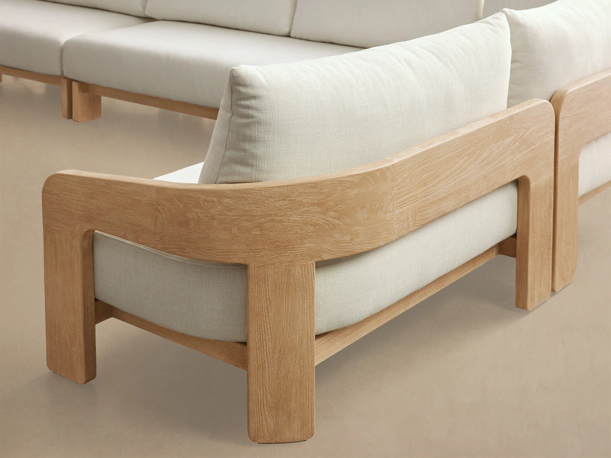 Front view of Anami Outdoor Four-Piece Sectional with light teak wood frame and off-white cushions arranged in an L-shape.