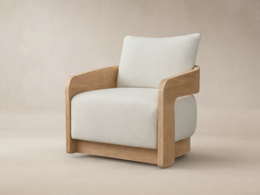 Anami Outdoor Swivel Chair with light teak wood frame, curved arms, and thick cream cushions, shown from a front-right angle.