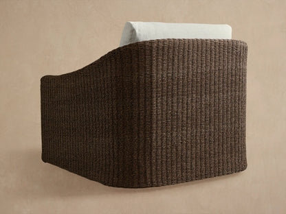 Close-up of Ancona Outdoor Swivel Chair's dark brown handwoven all-weather wicker and light off-white cushions.