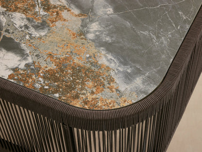 Anzio Outdoor Coffee Table with dark brown handwoven rope base & rectangular dark gray sintered stone top with white & gold veining.