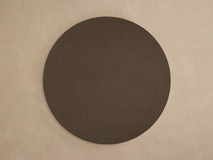 Close-up, angled view of the dark brown Azores Outdoor Round Coffee Table. Features textured faux travertine concrete finish.